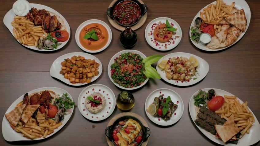 Overhead view of a full spread of Arabisca dishes